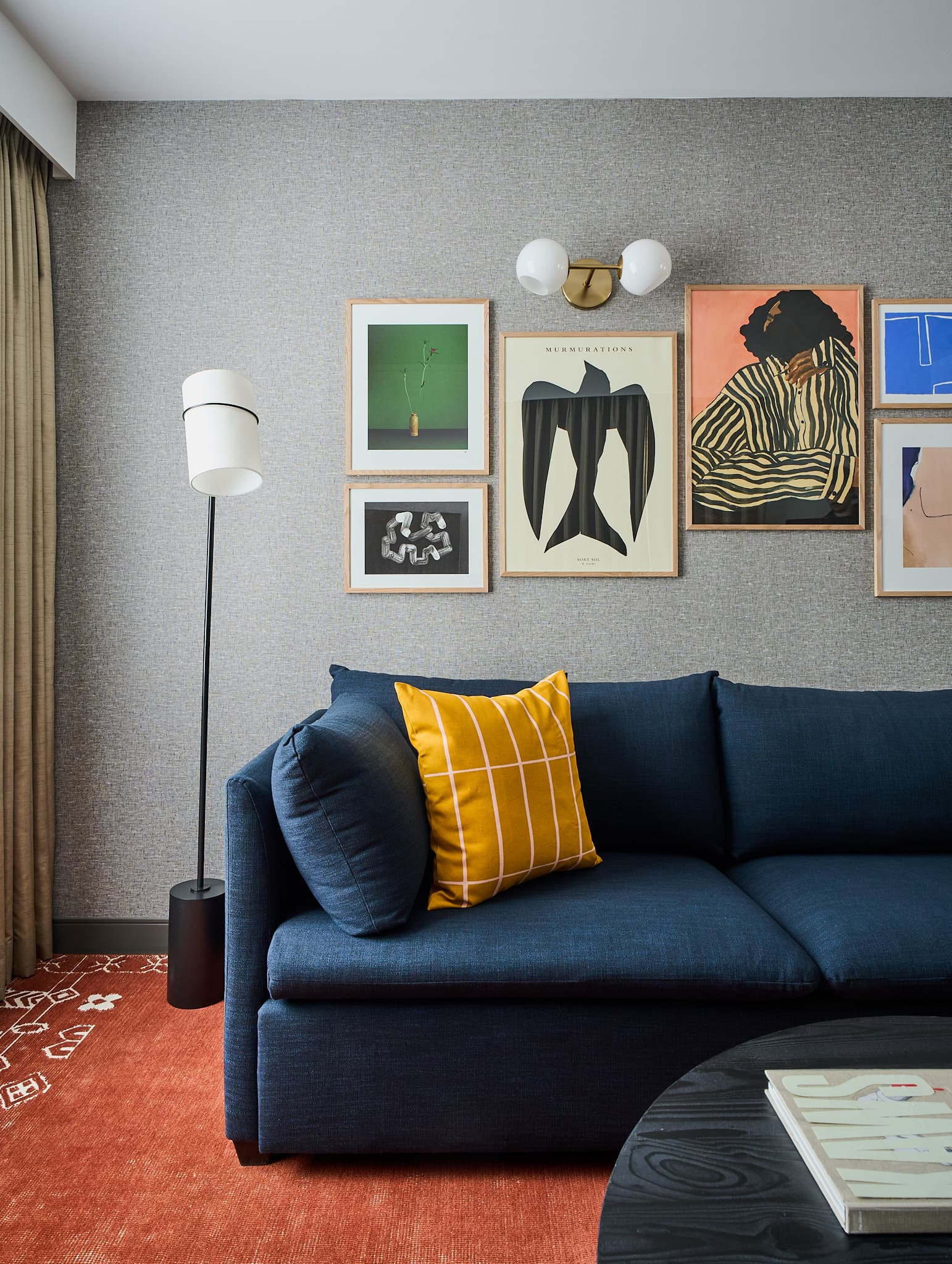 Decorative art above sofa inside Houston one-bedroom apartment